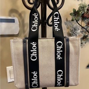 Chloe beige woody tote, leather trims and logo taped top handles.